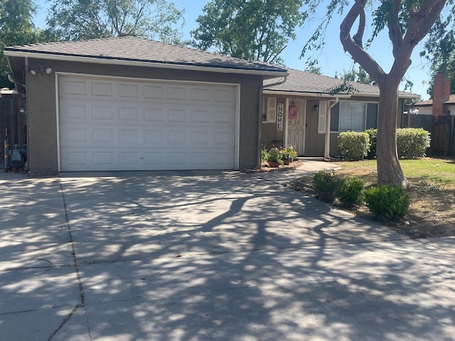 3317 W Indianapolis Ave, Fresno, CA 93722 - ranch-style house featuring driveway, stucco siding, and a garage