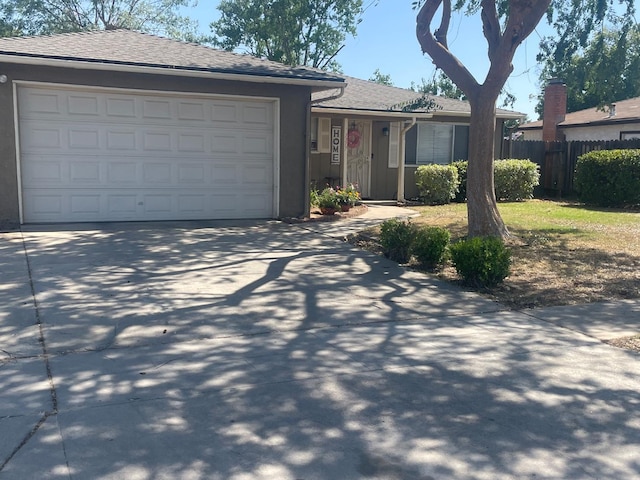 3317 W Indianapolis Ave, Fresno, CA 93722 - single story home with driveway, a garage, stucco siding, and roof with shingles