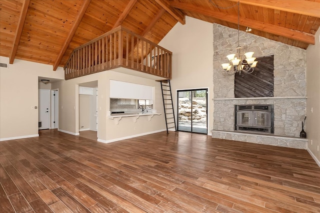 42617 John Muir Dr, Coarsegold, CA 93614 - unfurnished living room with a chandelier, a wooden ceiling with exposed beams, high vaulted ceiling, heating unit, and wood finished floors