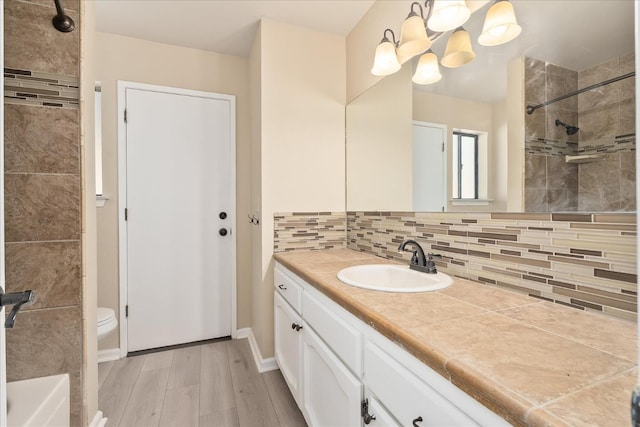 42617 John Muir Dr, Coarsegold, CA 93614 - bathroom with vanity, wood finished floors, backsplash, and tiled shower