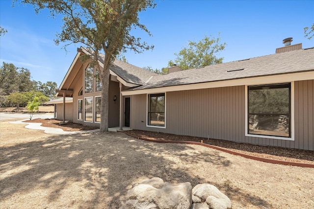 42617 John Muir Dr, Coarsegold, CA 93614 - view of front of house featuring a chimney and roof with shingles