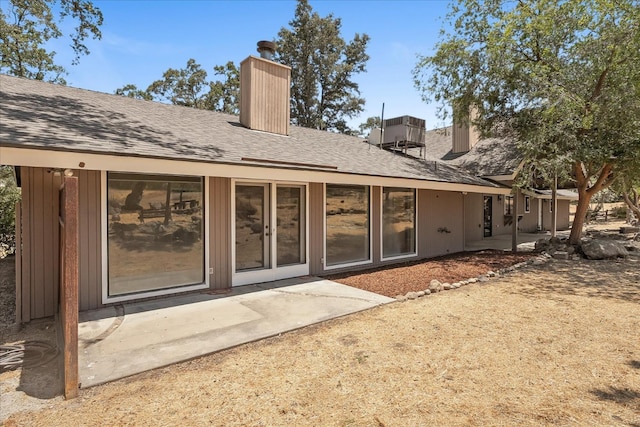 42617 John Muir Dr, Coarsegold, CA 93614 - back of property with a chimney, a patio, and a shingled roof
