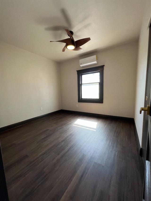 345 N Van Ness Ave, Fresno, CA 93701 - empty room featuring a wall mounted AC, dark wood finished floors, and ceiling fan
