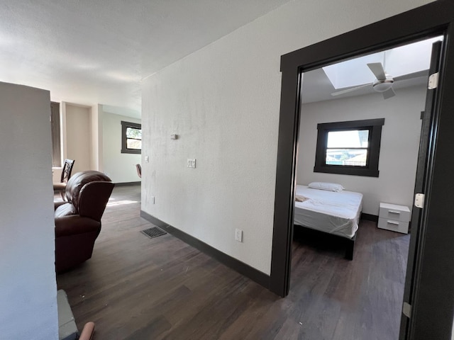 345 N Van Ness Ave, Fresno, CA 93701 - corridor with dark wood-style floors, plenty of natural light, and a skylight