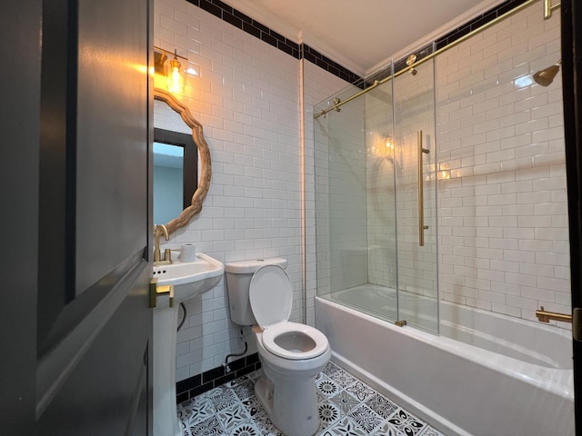 345 N Van Ness Ave, Fresno, CA 93701 - full bathroom featuring tile walls, bath / shower combo with glass door, ornamental molding, and tile patterned floors