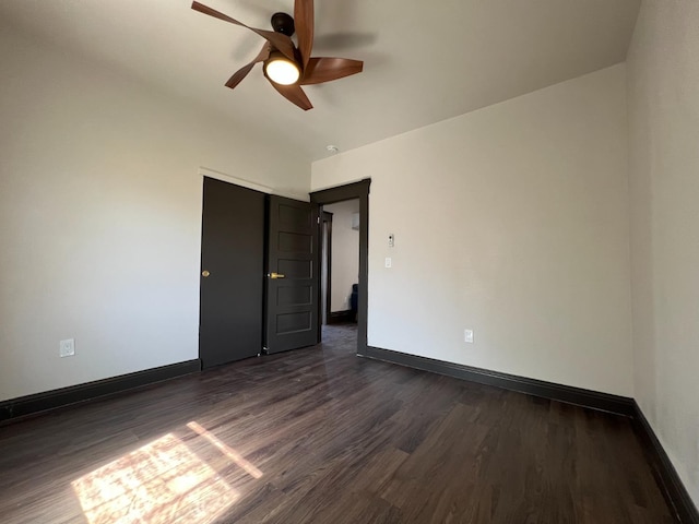 345 N Van Ness Ave, Fresno, CA 93701 - unfurnished bedroom featuring dark wood-type flooring, a ceiling fan, and a closet