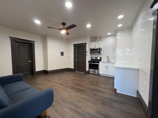345 N Van Ness Ave, Fresno, CA 93701 - living area with dark wood finished floors, a ceiling fan, and recessed lighting