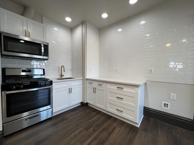 345 N Van Ness Ave, Fresno, CA 93701 - kitchen featuring stainless steel appliances, light countertops, backsplash, dark wood-style floors, and white cabinets