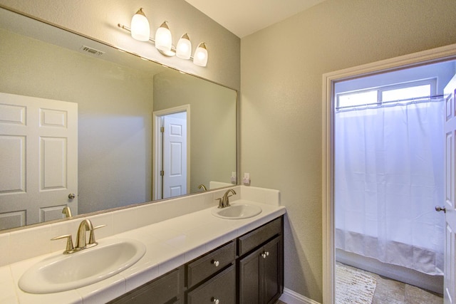 2286 N Janice Ave, Fresno, CA 93737 - bathroom with double vanity and baseboards