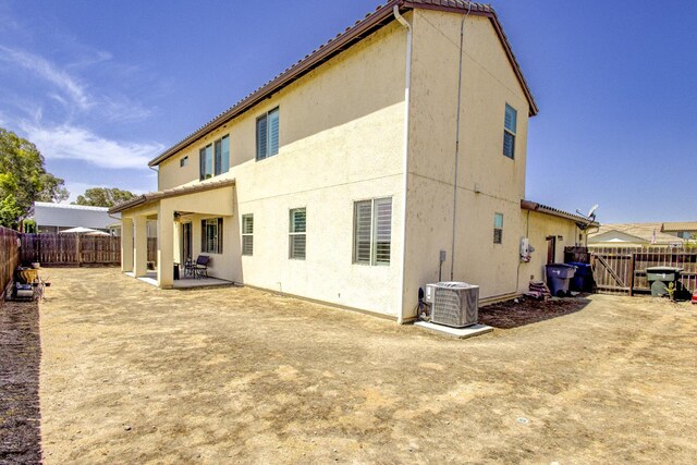 2286 N Janice Ave, Fresno, CA 93737 - rear view of house with a patio, a fenced backyard, and stucco siding