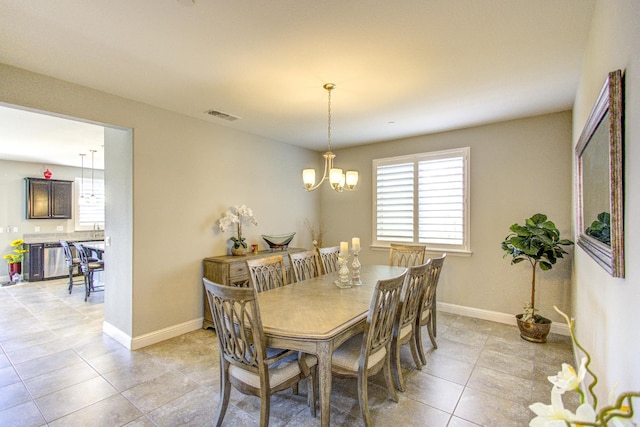 2286 N Janice Ave, Fresno, CA 93737 - dining area with light tile patterned floors and a chandelier