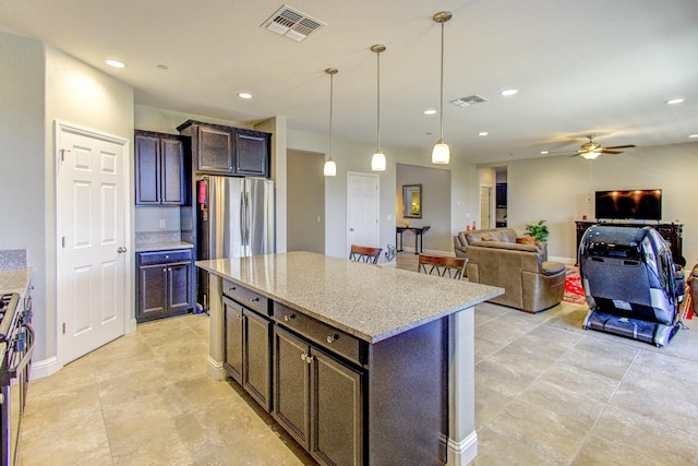 2286 N Janice Ave, Fresno, CA 93737 - kitchen with light stone counters, recessed lighting, pendant lighting, a ceiling fan, and dark brown cabinetry