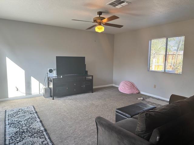 5509 E Crescent Ave, Fresno, CA 93727 - carpeted living room with a ceiling fan and baseboards