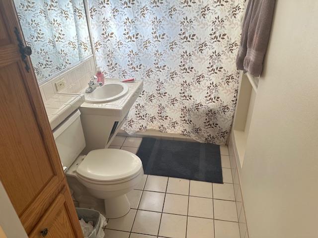 5509 E Crescent Ave, Fresno, CA 93727 - bathroom with tile patterned flooring, vanity, and a shower with shower curtain