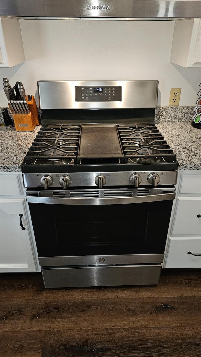 5509 E Crescent Ave, Fresno, CA 93727 - kitchen view of gas stove, dark wood-type flooring, white cabinets, and light stone counters