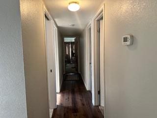 5509 E Crescent Ave, Fresno, CA 93727 - hallway featuring dark wood-type flooring and a textured wall
