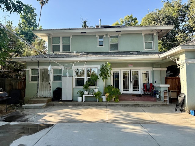 3728 E Huntington Blvd, Fresno, CA 93702 - rear view of house with french doors, stucco siding, and a shingled roof