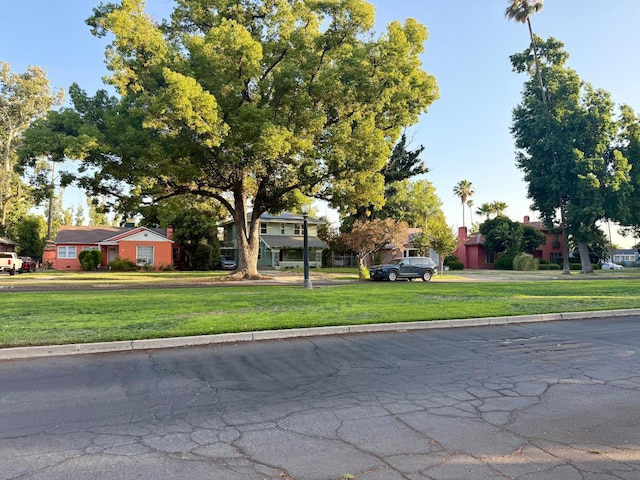 3728 E Huntington Blvd, Fresno, CA 93702 - view of property hidden behind natural elements with a front lawn