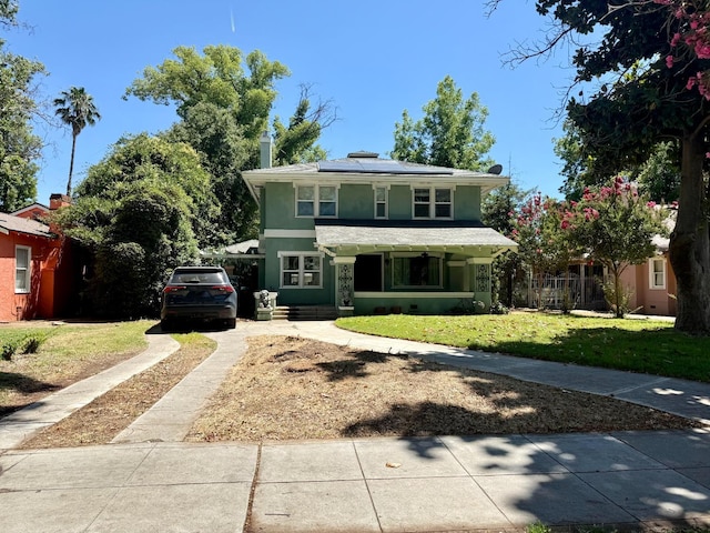 3728 E Huntington Blvd, Fresno, CA 93702 - american foursquare style home featuring driveway, a front yard, solar panels, stucco siding, and a porch