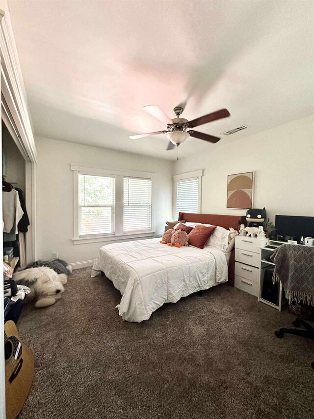 3728 E Huntington Blvd, Fresno, CA 93702 - bedroom featuring dark colored carpet, multiple windows, and ceiling fan