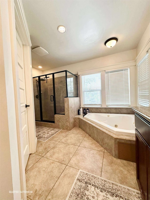 3728 E Huntington Blvd, Fresno, CA 93702 - bathroom featuring a tub with jets, a shower stall, and tile patterned floors