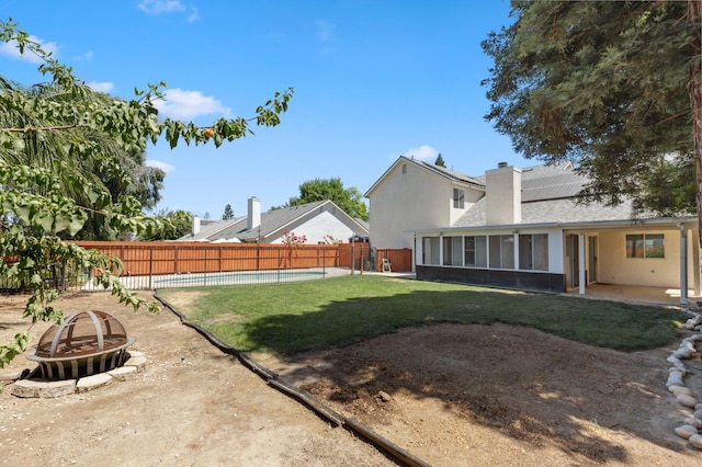 2111 Birch Ave, Clovis, CA 93611 - fenced backyard with an outdoor fire pit, a sunroom, and a patio