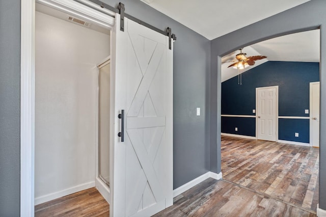2111 Birch Ave, Clovis, CA 93611 - hall featuring a barn door, wood finished floors, and vaulted ceiling