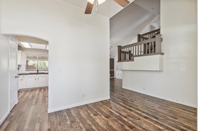 2111 Birch Ave, Clovis, CA 93611 - empty room with ceiling fan, hardwood / wood-style floors, arched walkways, stairs, and vaulted ceiling
