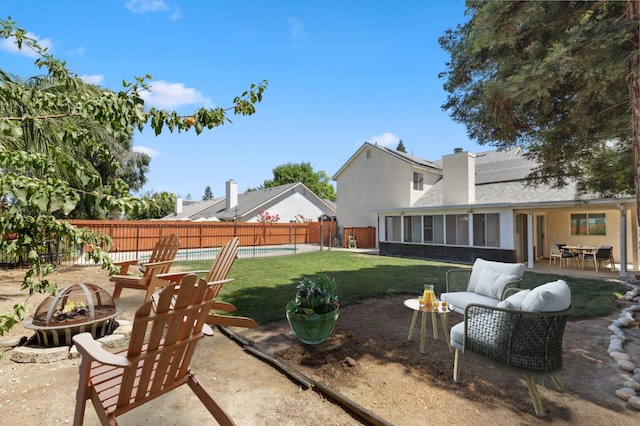 2111 Birch Ave, Clovis, CA 93611 - fenced backyard featuring a fire pit, a sunroom, a patio area, and outdoor dining area