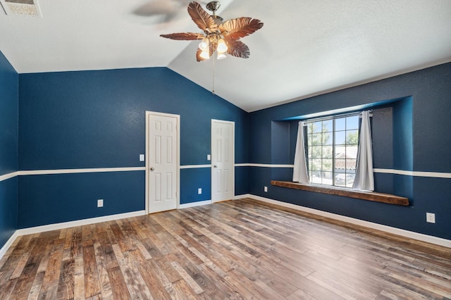 2111 Birch Ave, Clovis, CA 93611 - spare room with ceiling fan, vaulted ceiling, and wood finished floors