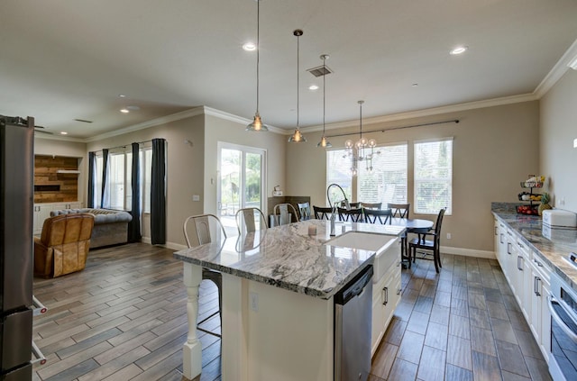 3211 Salem Ave, Clovis, CA 93619 - kitchen with a breakfast bar area, stainless steel appliances, white cabinets, wood finish floors, and recessed lighting