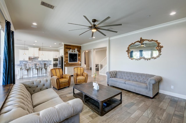 3211 Salem Ave, Clovis, CA 93619 - living room featuring a ceiling fan, light wood finished floors, recessed lighting, and ornamental molding