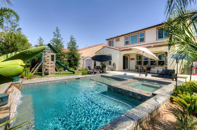 3211 Salem Ave, Clovis, CA 93619 - view of pool featuring a patio area, outdoor dining area, a playground, an outdoor living space, and a pool with connected hot tub