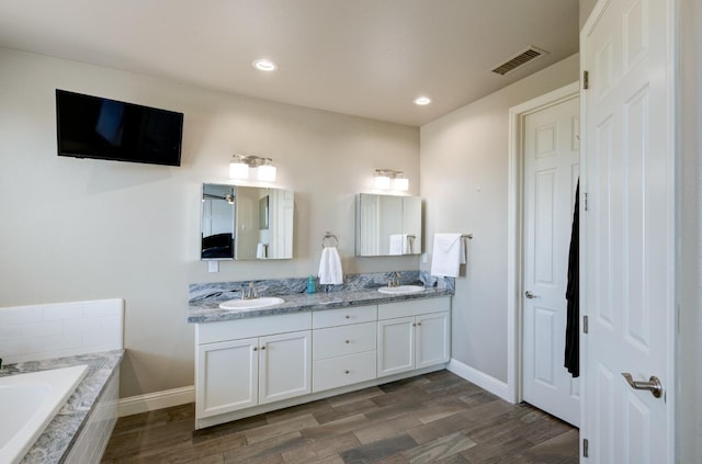 3211 Salem Ave, Clovis, CA 93619 - full bath featuring double vanity, a bath, wood finished floors, and recessed lighting