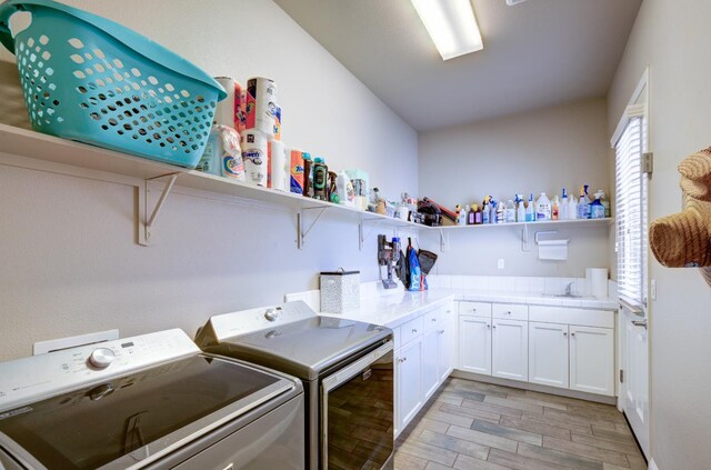 3211 Salem Ave, Clovis, CA 93619 - washroom featuring independent washer and dryer, light wood finished floors, and cabinet space