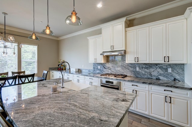 3211 Salem Ave, Clovis, CA 93619 - kitchen with stainless steel appliances, under cabinet range hood, decorative backsplash, white cabinets, and ornamental molding