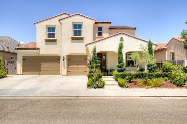 3211 Salem Ave, Clovis, CA 93619 - mediterranean / spanish house featuring a tiled roof, stucco siding, an attached garage, and driveway