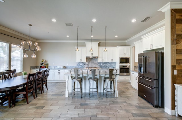 3211 Salem Ave, Clovis, CA 93619 - kitchen with stainless steel appliances, backsplash, white cabinetry, a center island with sink, and hanging light fixtures