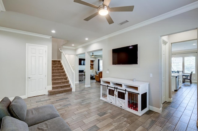 3211 Salem Ave, Clovis, CA 93619 - living room with ceiling fan, crown molding, wood finished floors, stairway, and a fireplace