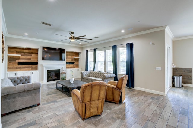 3211 Salem Ave, Clovis, CA 93619 - living room featuring a ceiling fan, a glass covered fireplace, recessed lighting, ornamental molding, and light wood-style floors