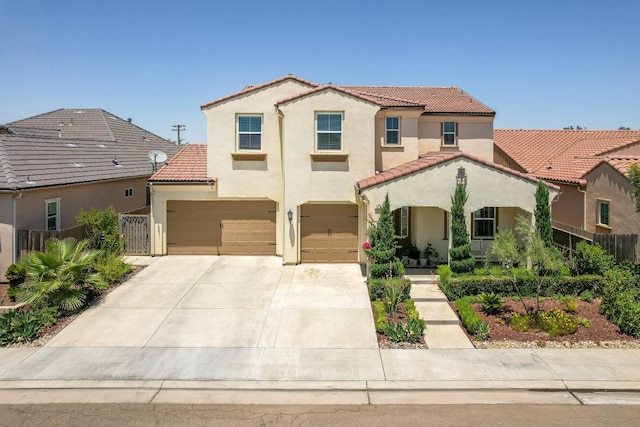 3211 Salem Ave, Clovis, CA 93619 - mediterranean / spanish-style home featuring a tiled roof, stucco siding, driveway, and a garage