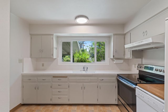 1432 E Holland Ave, Fresno, CA 93704 - kitchen featuring under cabinet range hood, stainless steel range with electric cooktop, white dishwasher, tasteful backsplash, and tile counters
