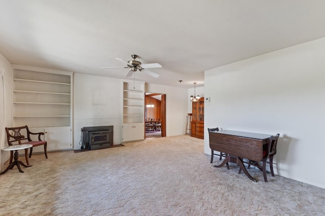 1432 E Holland Ave, Fresno, CA 93704 - carpeted living room featuring a wood stove, ceiling fan, and built in features