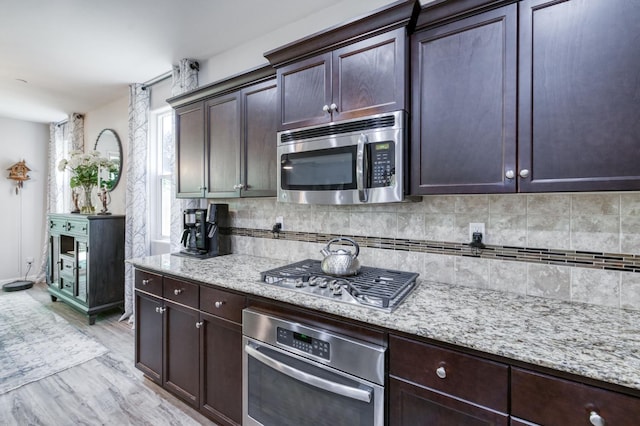 3562 Luminary Way, Clovis, CA 93619 - kitchen with appliances with stainless steel finishes, decorative backsplash, light stone countertops, and dark brown cabinets