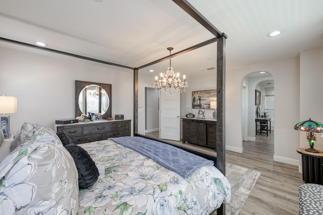3562 Luminary Way, Clovis, CA 93619 - bedroom featuring arched walkways, wood finished floors, a chandelier, and recessed lighting