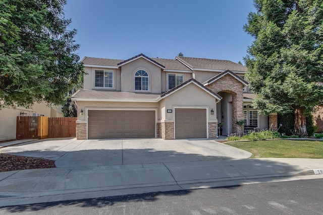 1966 Decatur Ave, Clovis, CA 93611 - view of front facade with stone siding, stucco siding, driveway, and a garage