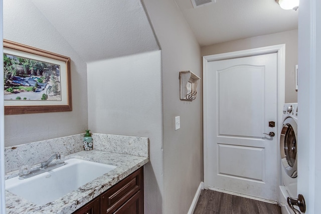 1966 Decatur Ave, Clovis, CA 93611 - bathroom with wood finished floors, washer / dryer, and vanity