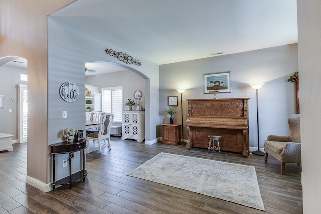 1966 Decatur Ave, Clovis, CA 93611 - living room with arched walkways and dark wood-type flooring