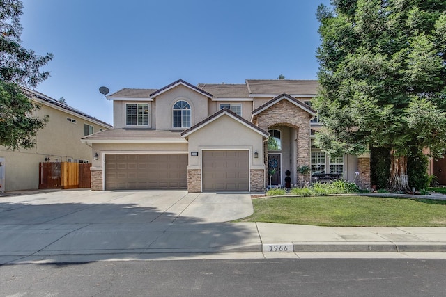 1966 Decatur Ave, Clovis, CA 93611 - traditional home featuring stone siding, stucco siding, an attached garage, and concrete driveway