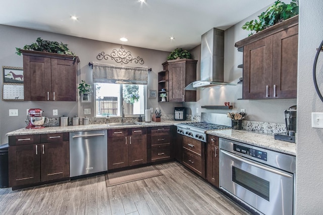 1966 Decatur Ave, Clovis, CA 93611 - kitchen with appliances with stainless steel finishes, wall chimney range hood, dark brown cabinetry, light wood finished floors, and open shelves
